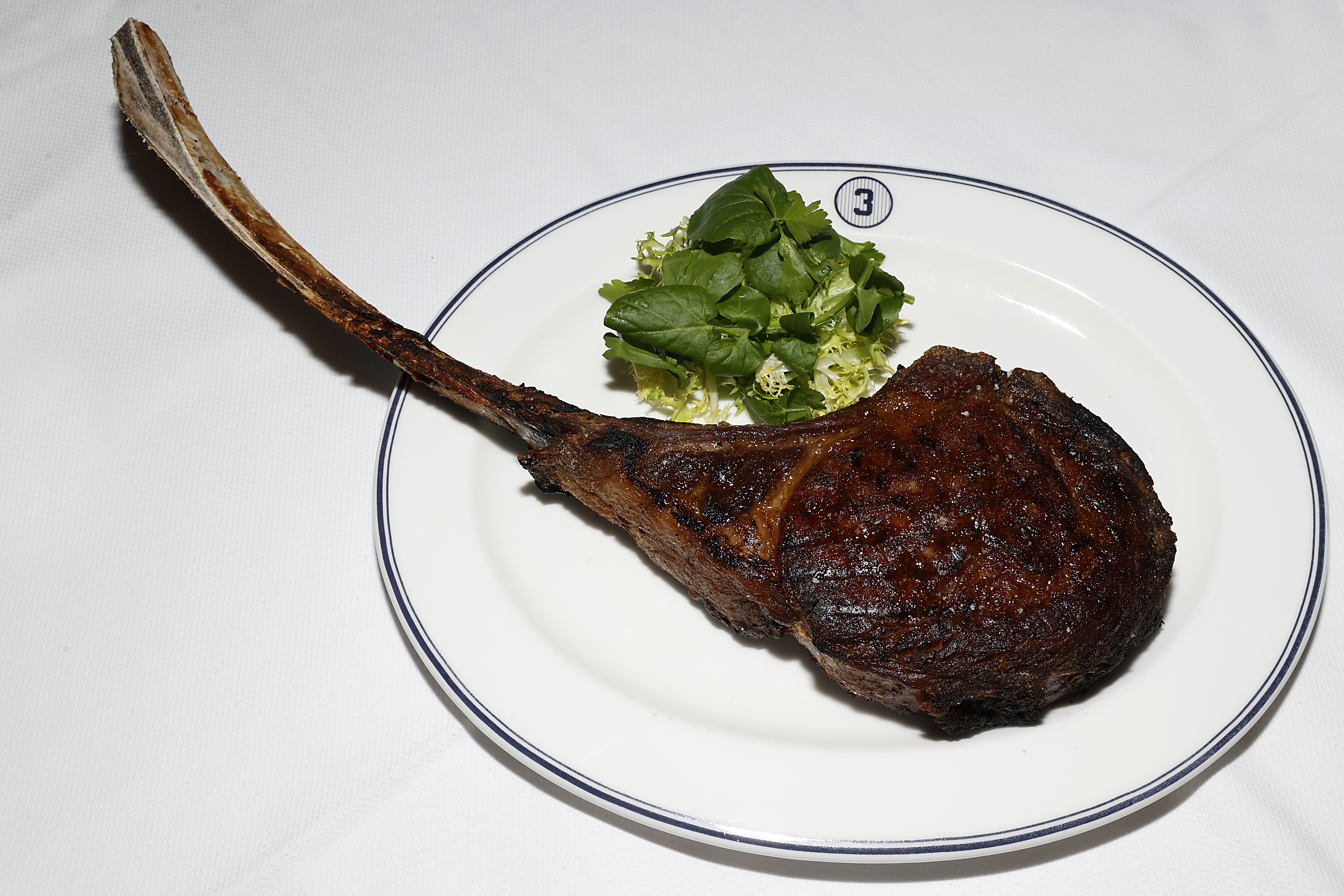 A showy ribeye from a grand New York steakhouse seems to exist on a different planet from a hot dog or a halal platter sold out of a cart on a busy street. That doesn’t make it better, and it doesn’t make it worse. What it represents is simply one end of a cultural spectrum. (Photo Credit: New York Yankees)