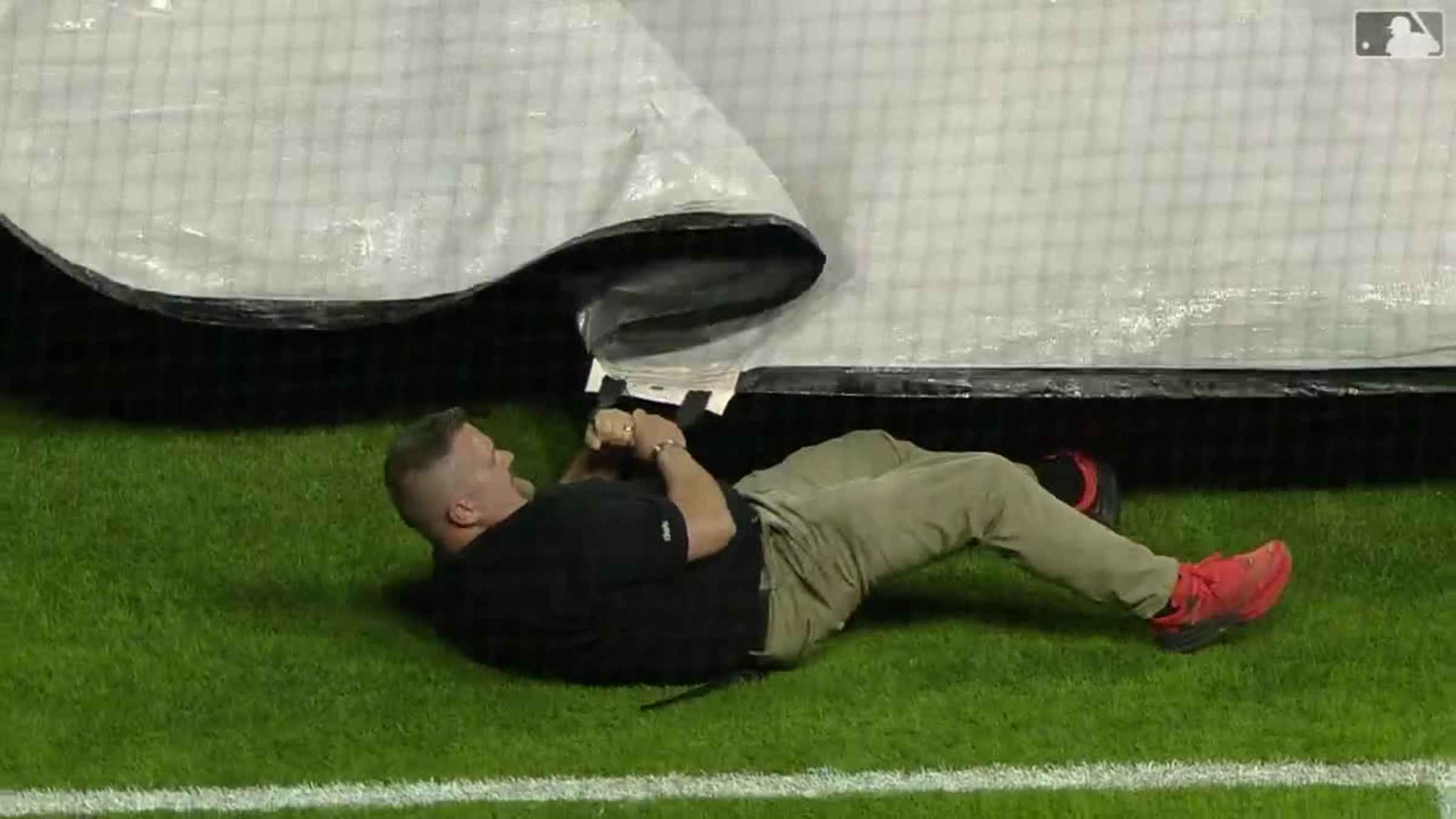 TarpGuy gets pulled under when grounds crew rolls field cover at