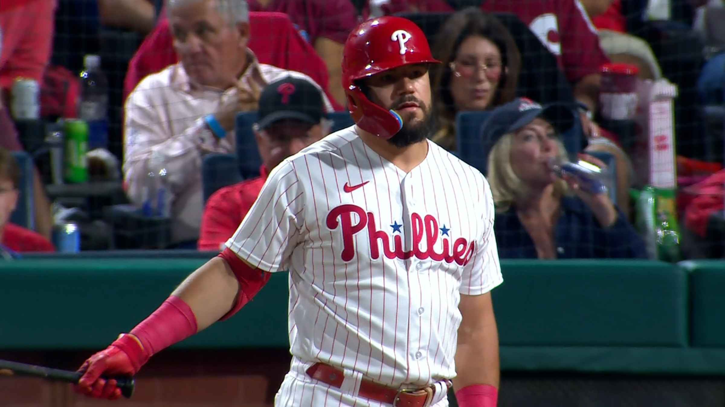 Chicago Cubs' Kyle Schwarber watches his RBI triple off Cincinnati