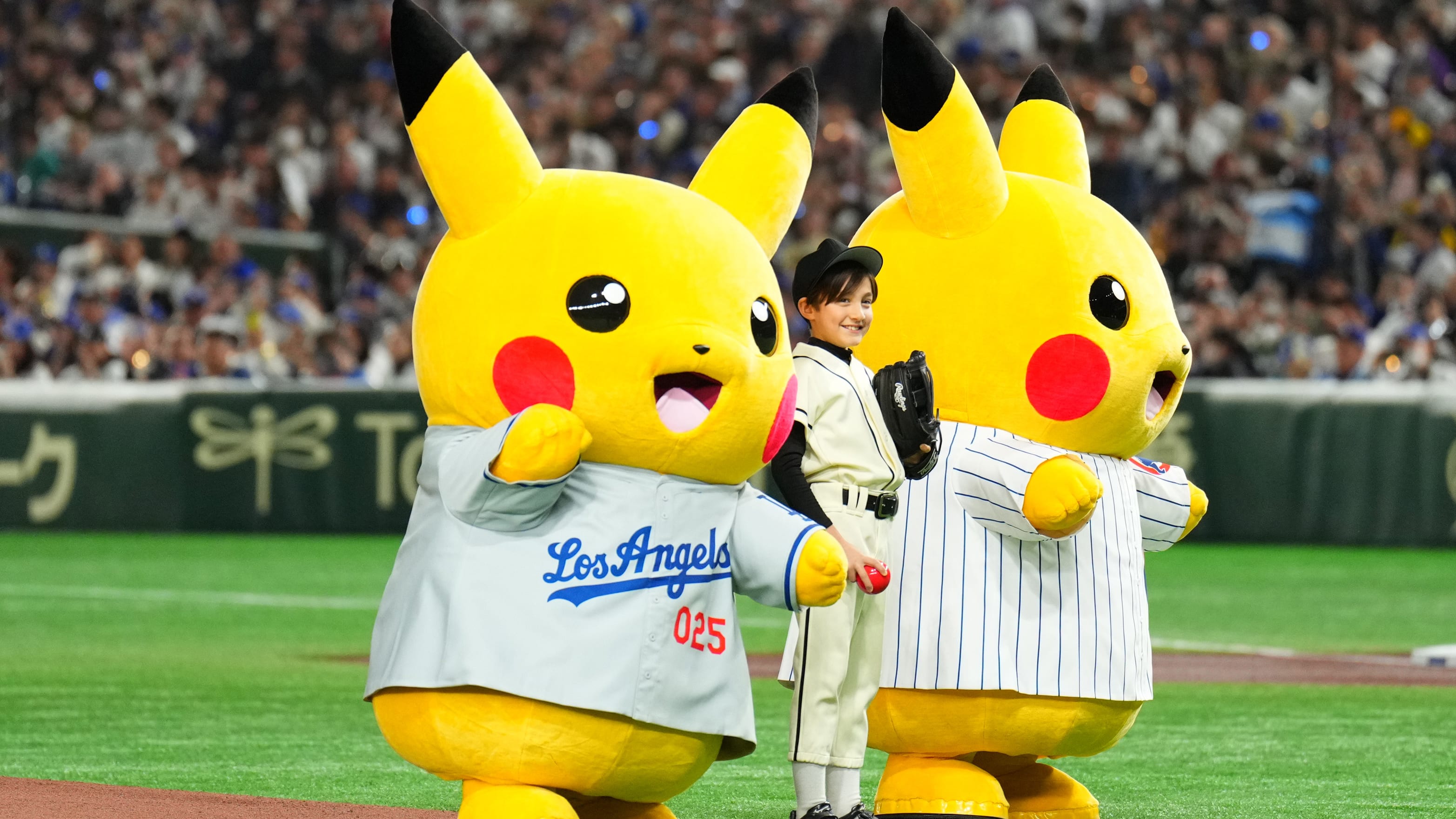 Two Pokémon characters join a young fan at the Tokyo Dome on Tuesday