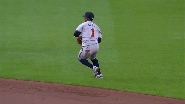 Ozzie Albies makes a jump throw for the out