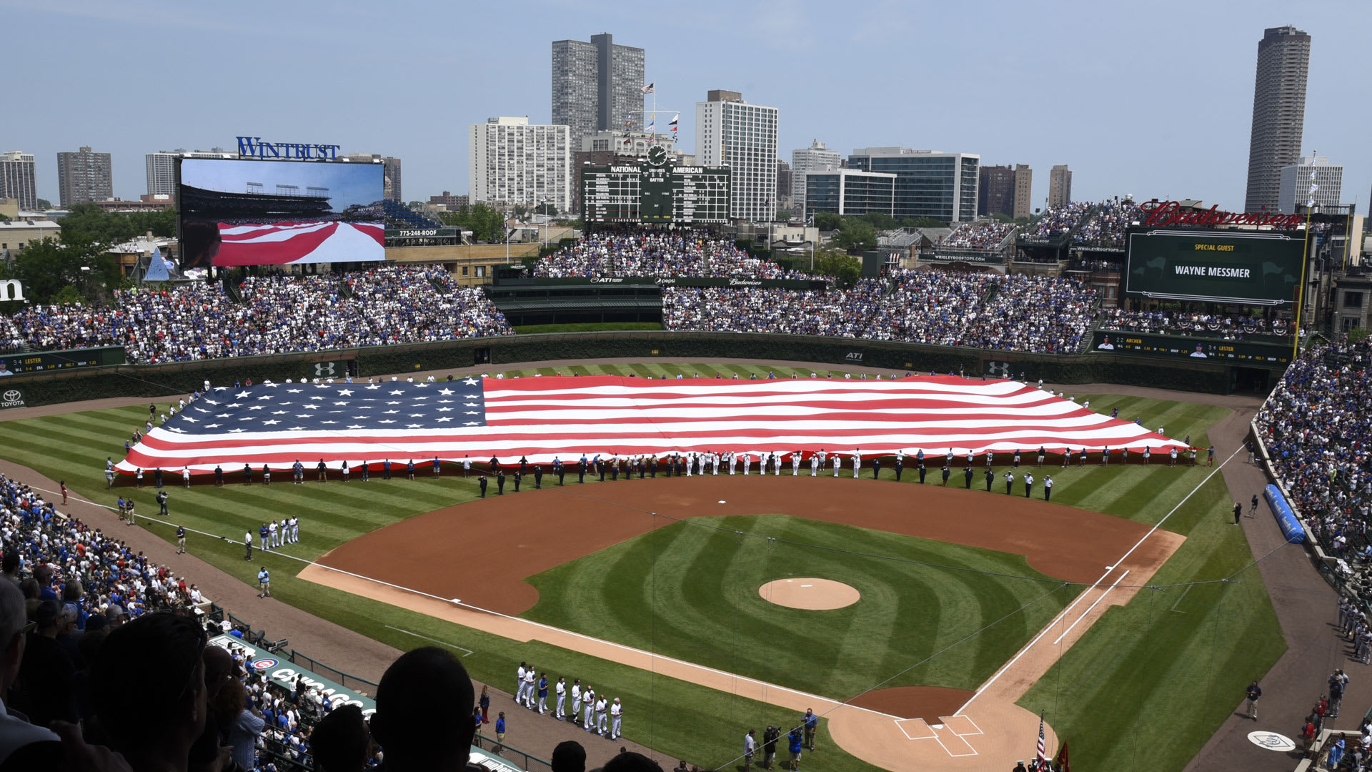 An American flag stretched across the outfield