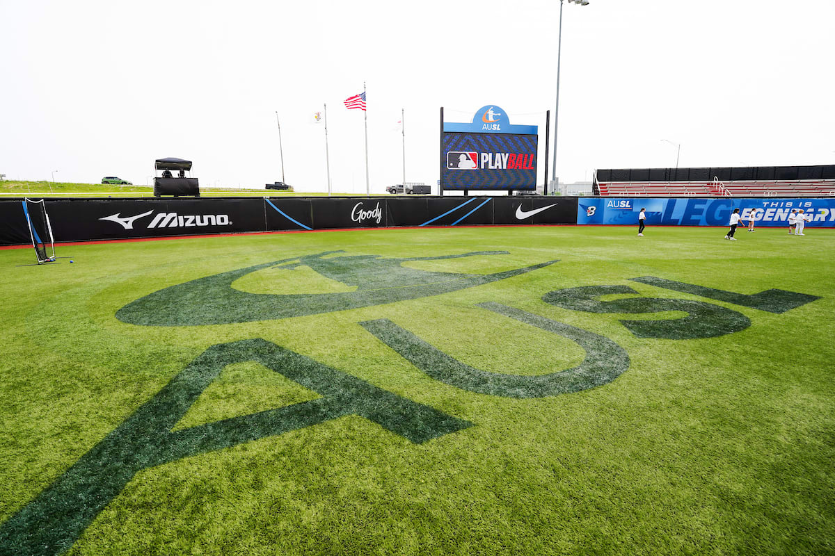 AUSL emblazoned on the turf of a softball field