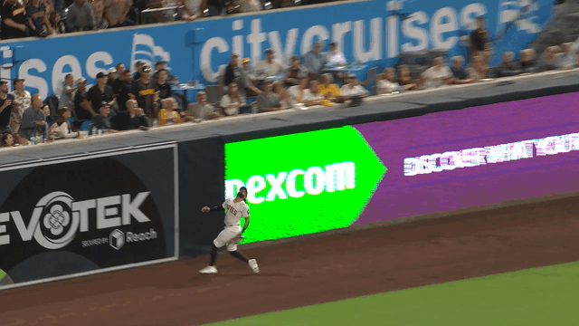 An animated gif of Fernando Tatis Jr. leaping to rob a home run