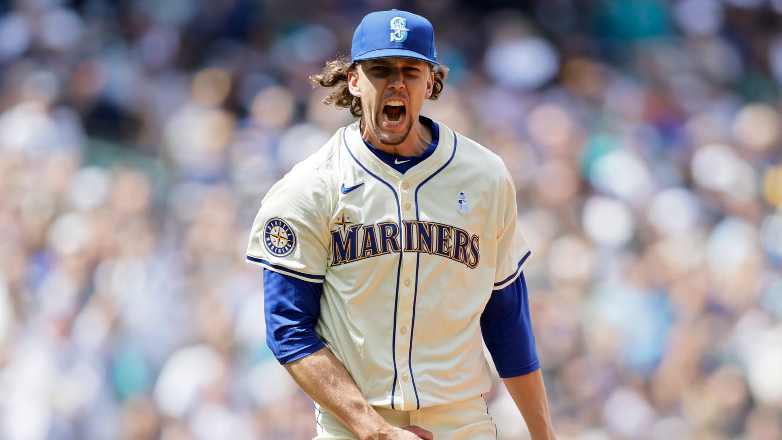 Logan Gilbert celebrates after completing the eighth inning