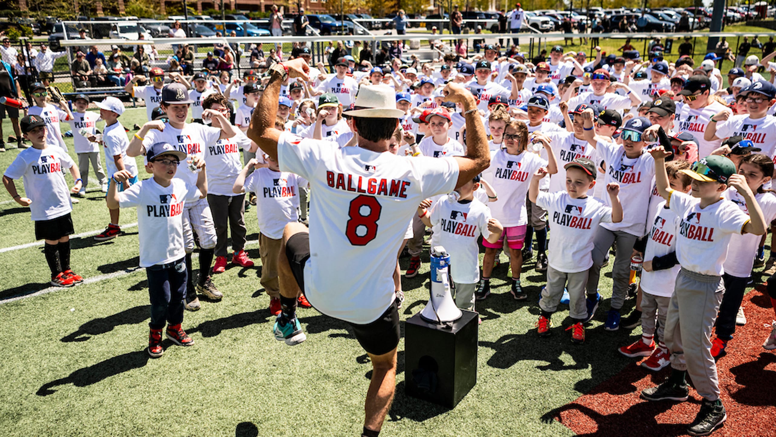 A speaker addresses kids at a Play Ball event