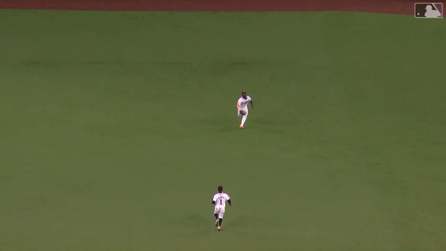 An animated gif of Michael Harris II making a diving catch and coming to a sliding stop