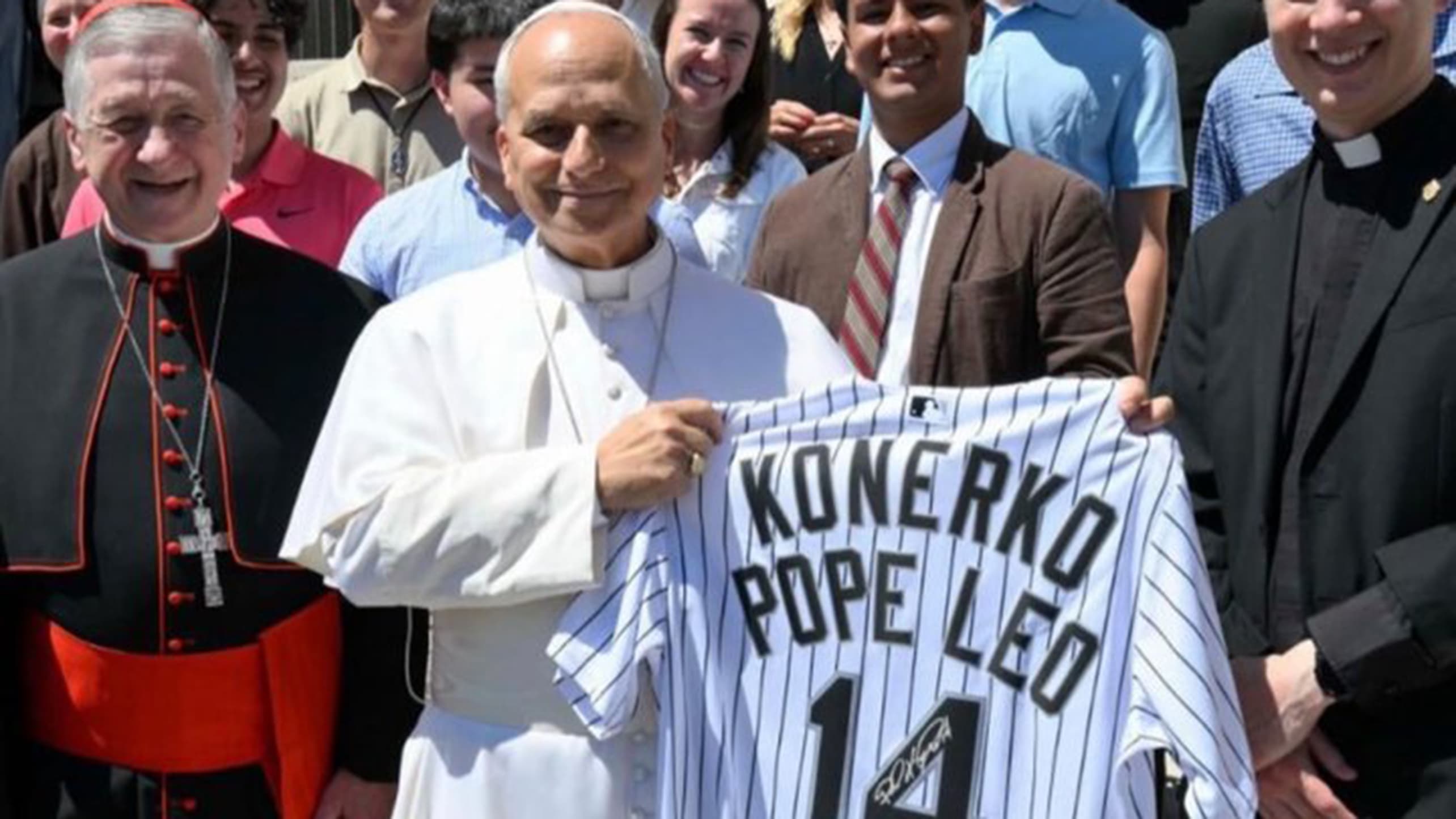 Pope Leo holds up a signed Paul Konerko jersey