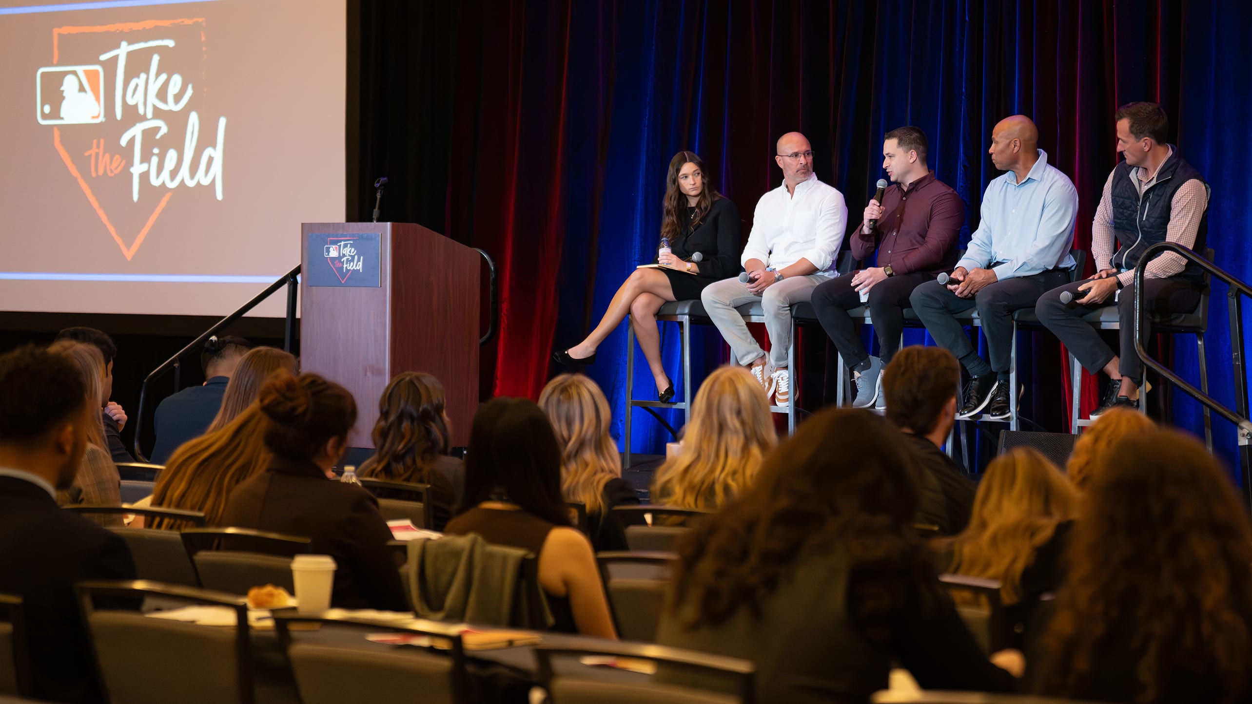 Five panelists talk on stage at MLB's Take the Field program