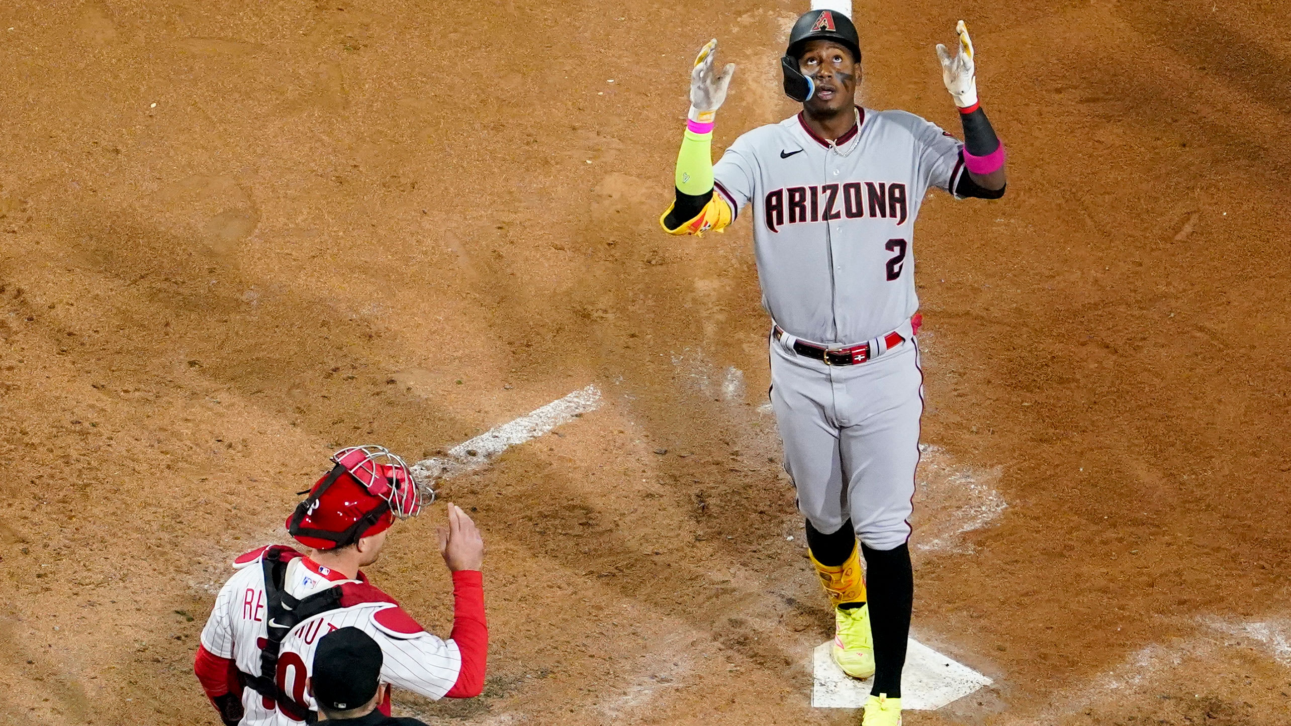 Geraldo Perdomo steps on home plate and looks to the sky