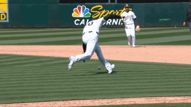 An animated gif of Lucas Erceg knocking the ball toward first base with his glove