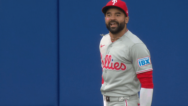 An animated gif of Phillies center fielder Derek Hill bouncing and nodding his head in celebration