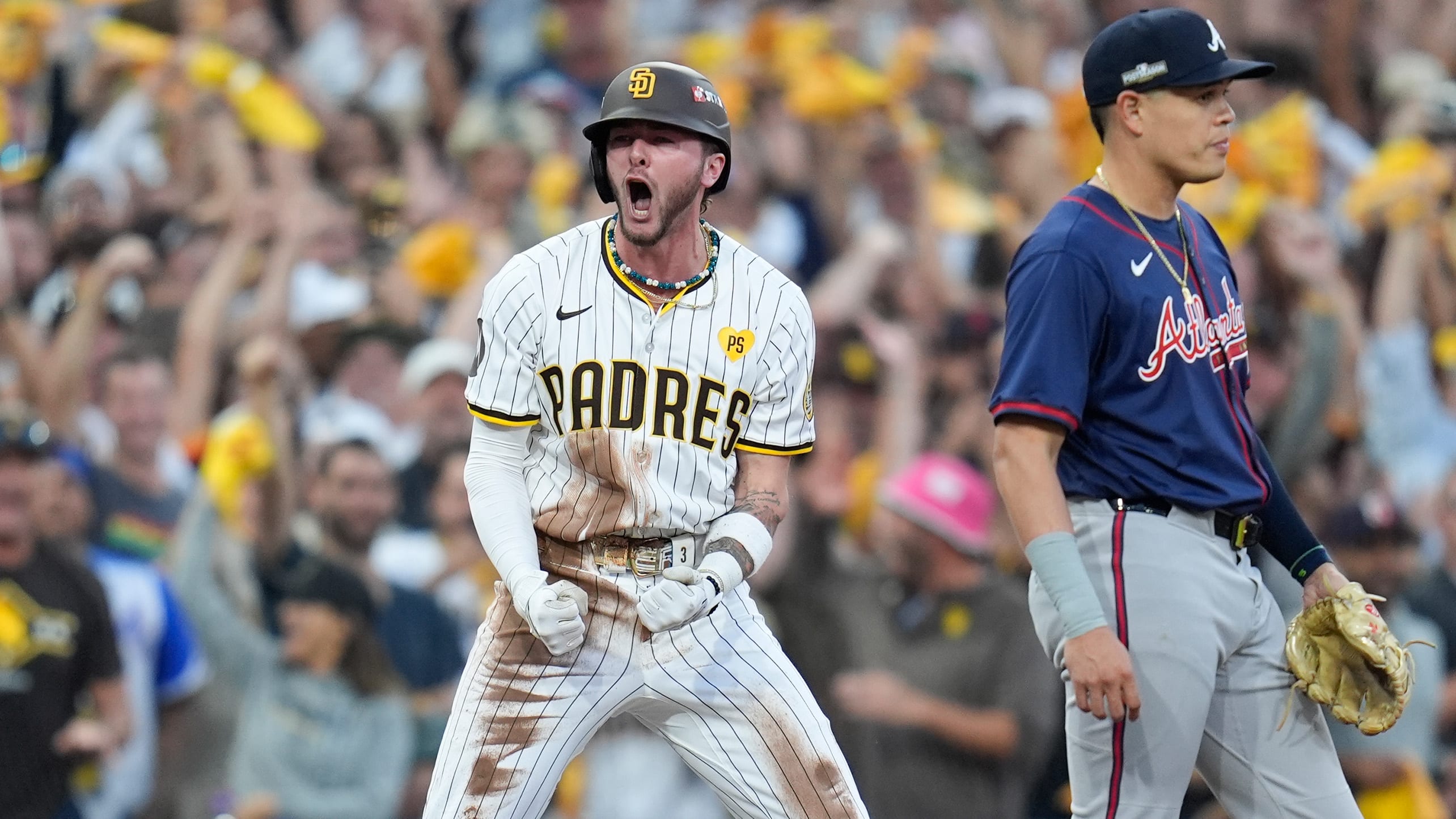 Jackson Merrill lets out a yell at third base after hitting a two-run triple