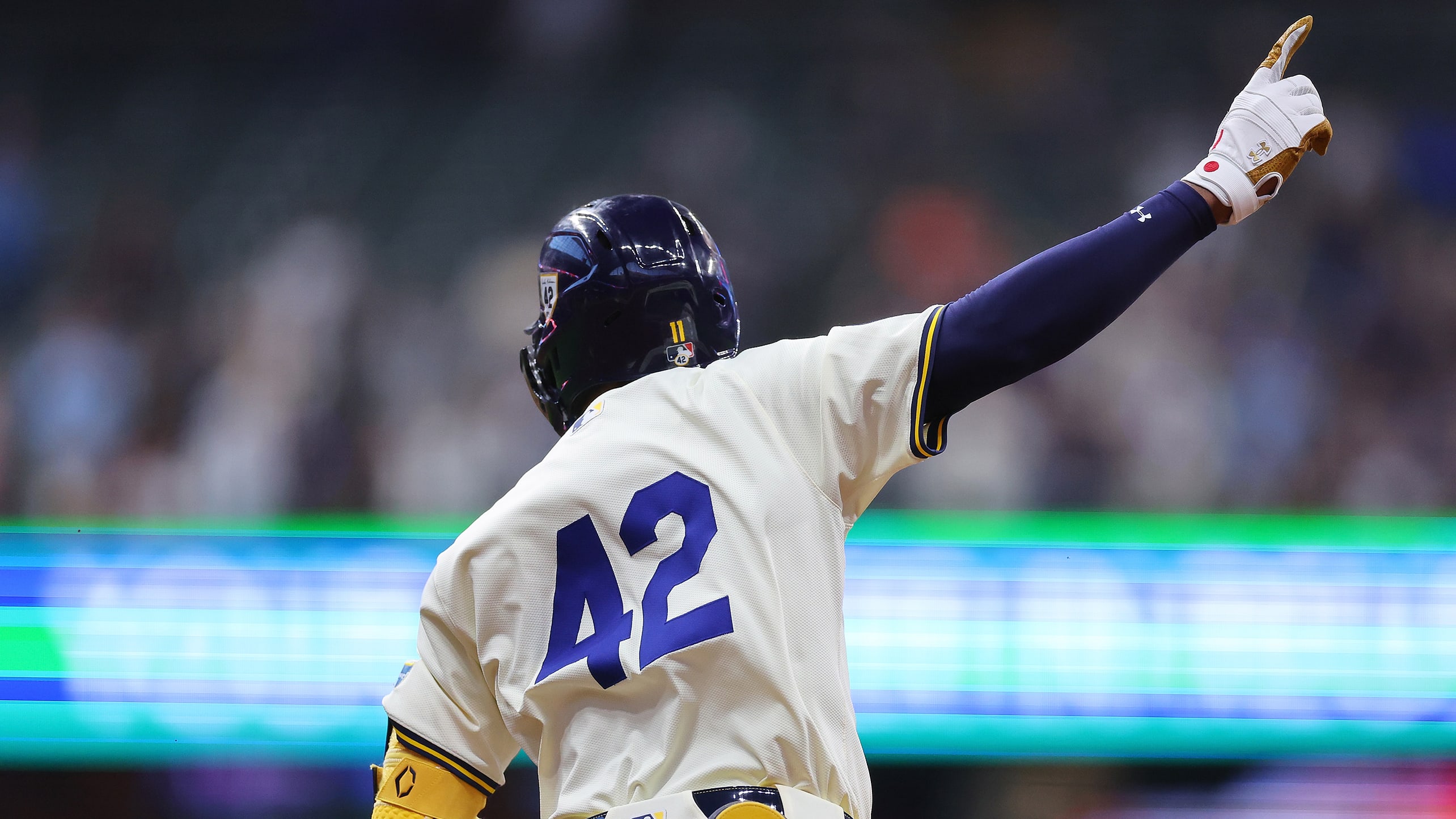 Jackson Chourio raises his arm as he rounds the bases after a home run