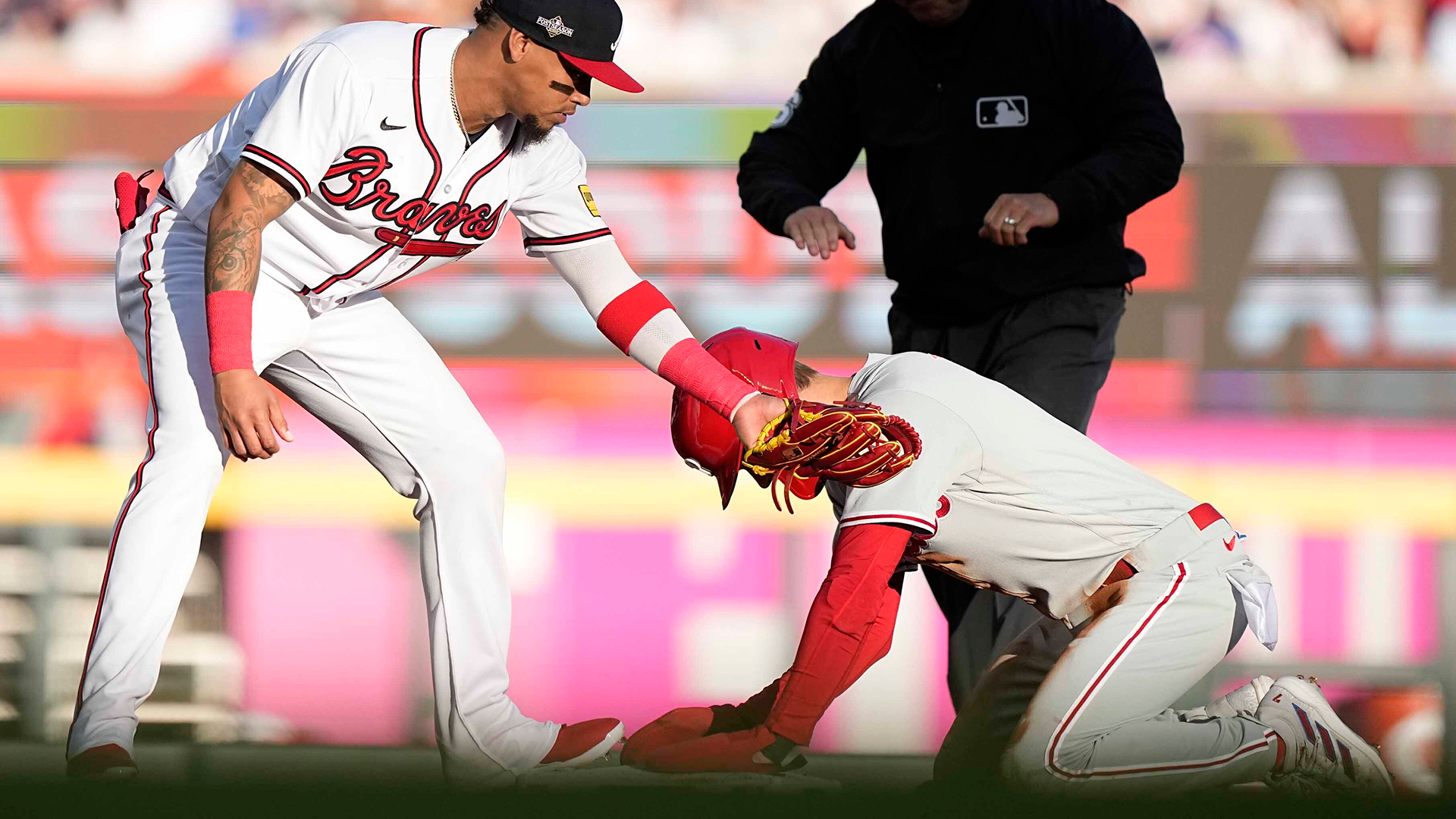 Trea Turner kneels with his hands on second base after stealing the bag