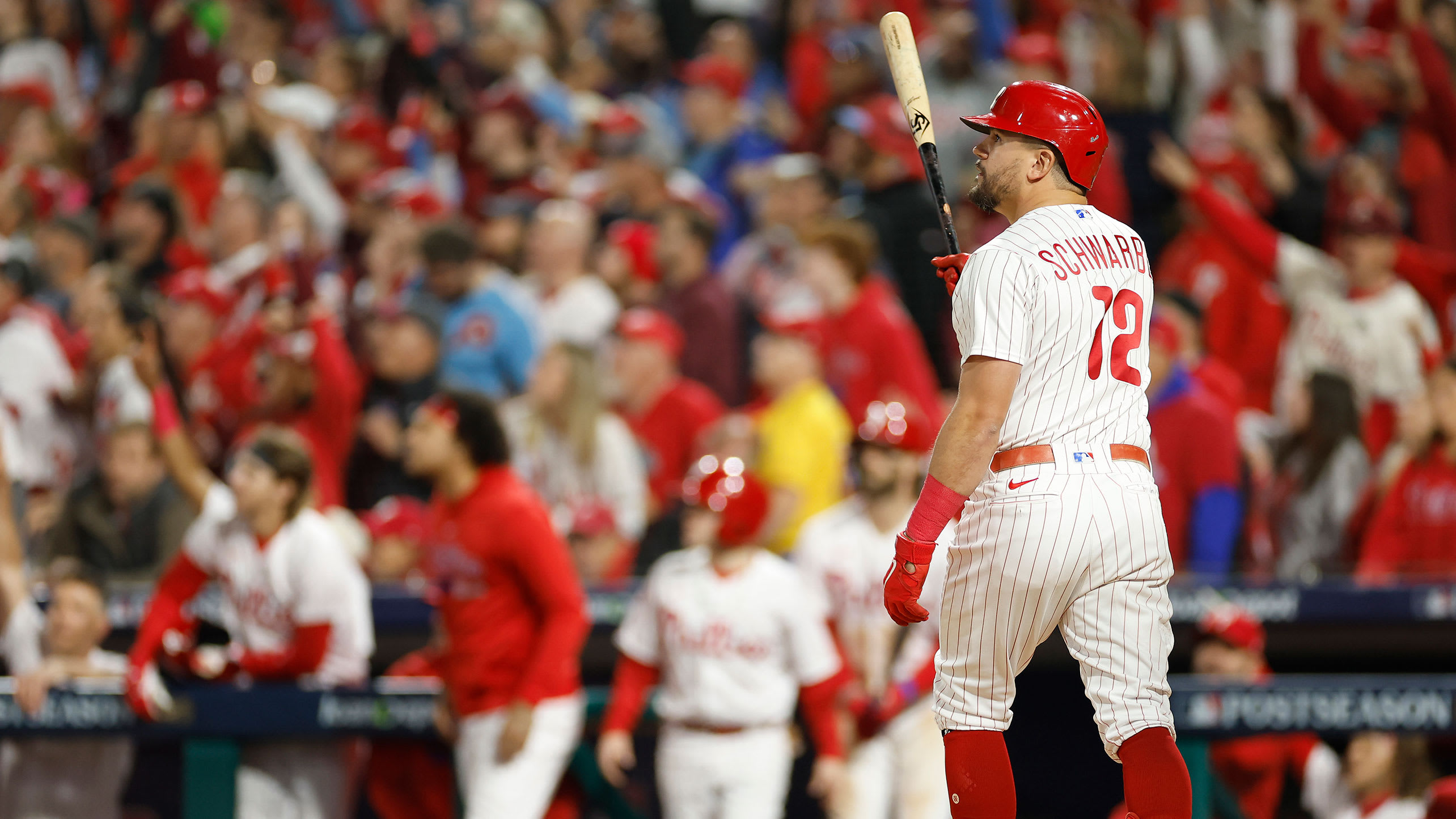 Kyle Schwarber watches the flight of his second home run