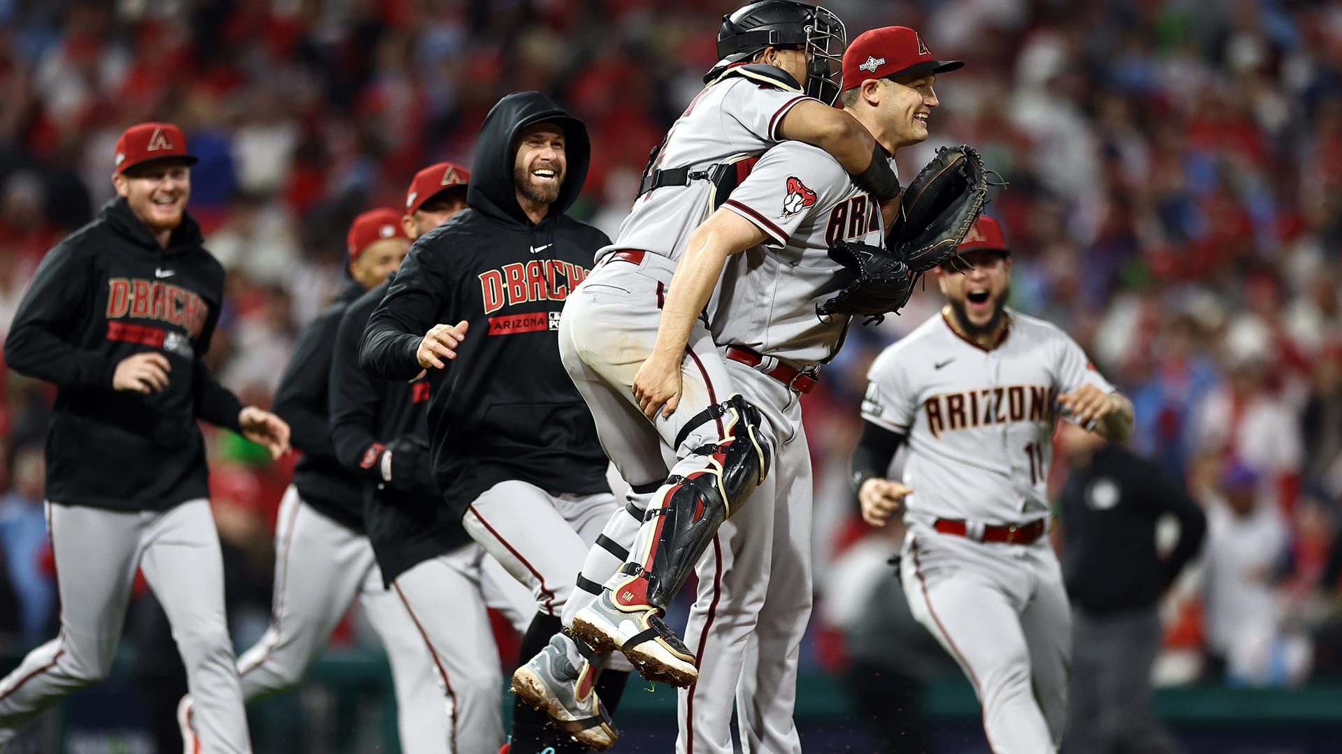 The D-backs rush to Paul Sewald to celebrate winning the NLCS