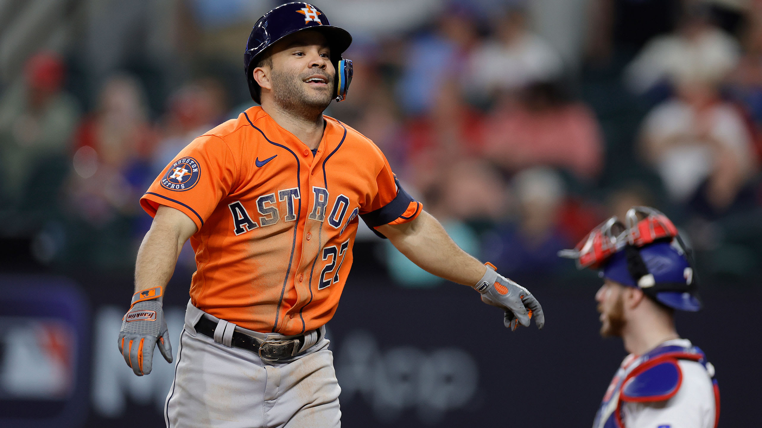 Jose Altuve smiles after scoring a run