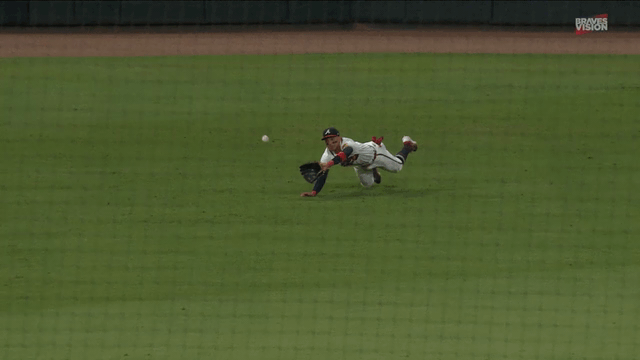 An animated gif of Mauricio Dubón making a diving catch