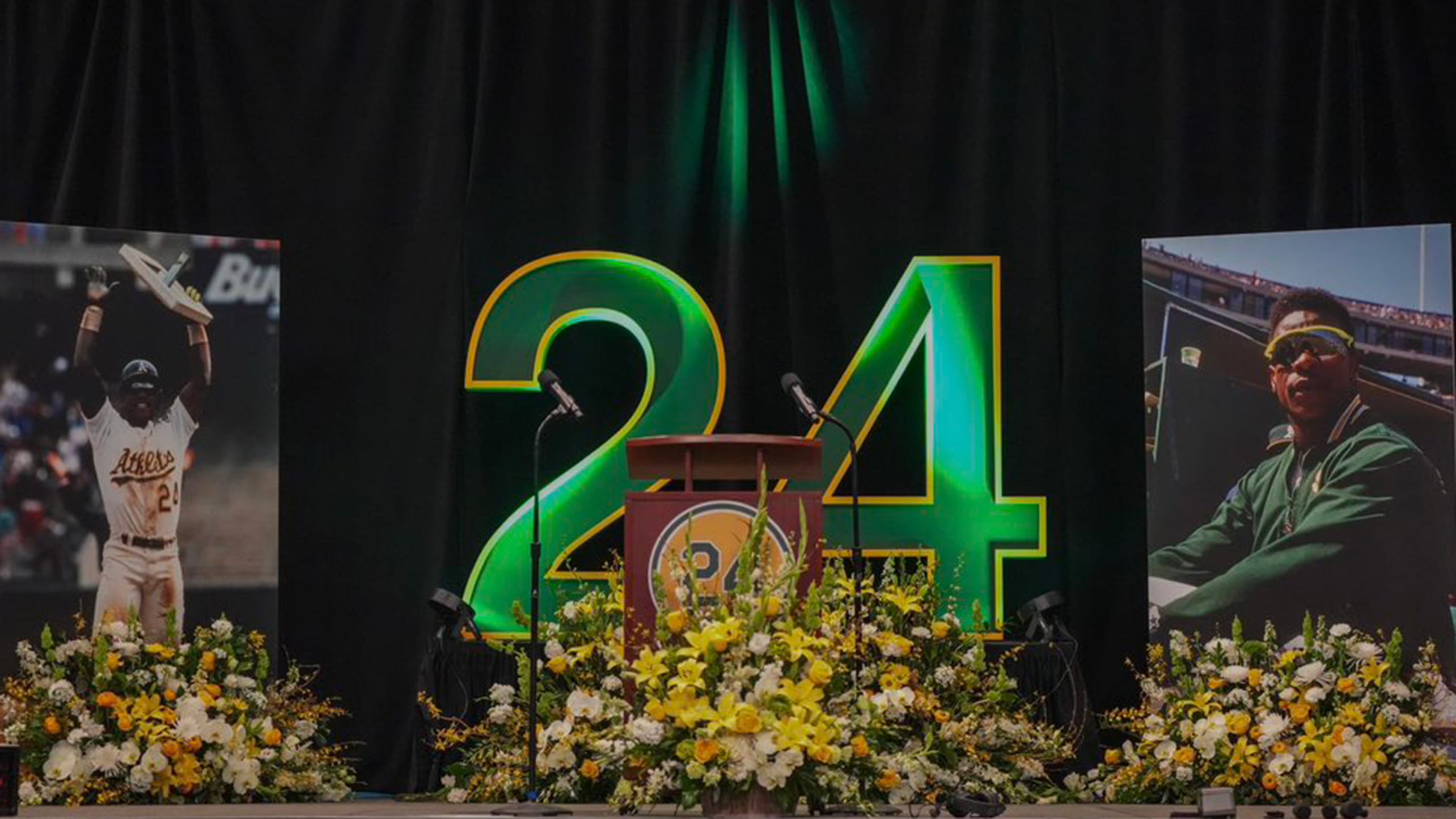 Photos of Rickey Henderson and the No. 24 adorn a stage