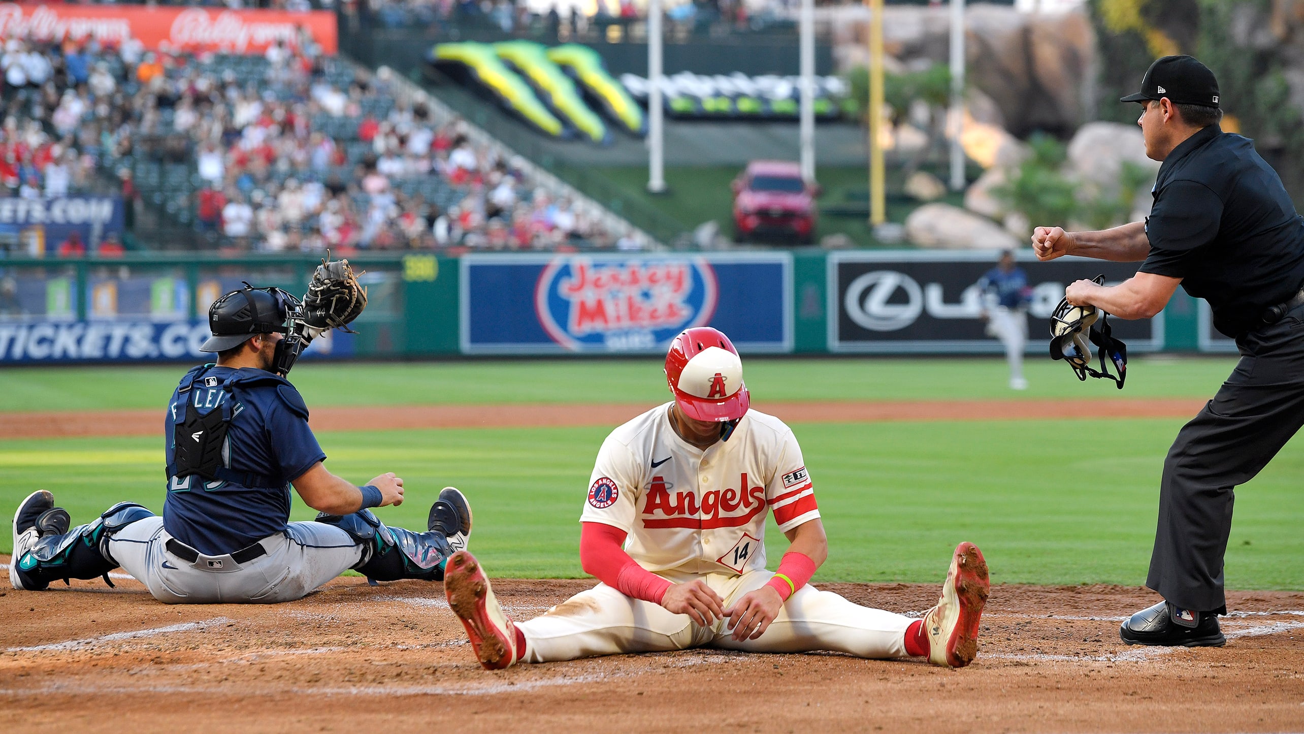 Logan O'Hoppe is called out at the plate as Cal Raleigh shows the umpire the ball