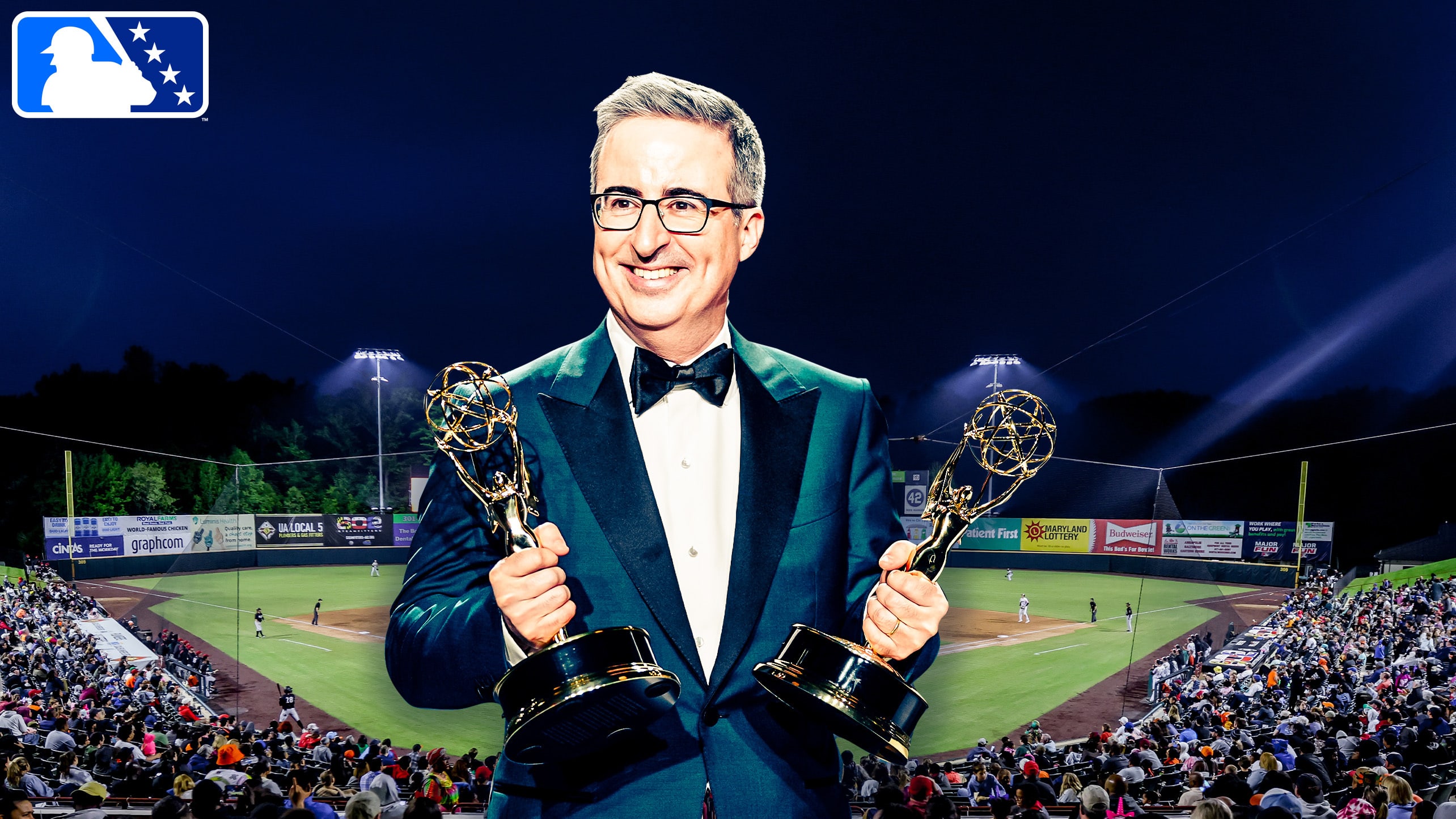 Illustration of John Oliver with Emmys in front of a Minor League field