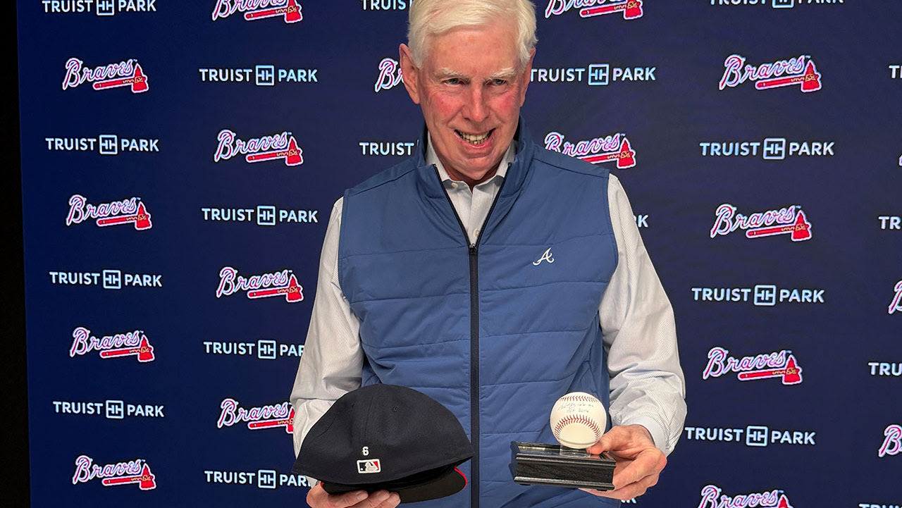 Terry McGuirk with ball signed by Bobby Cox
