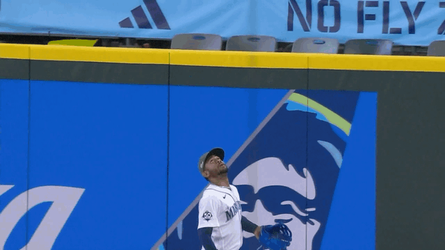 An animated gif of Julio Rodríguez robbing a homer in front of a sign reading 'No Fly Zone'