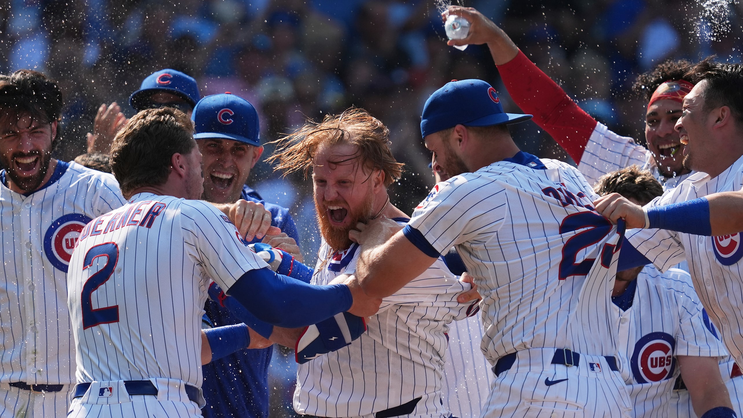 Justin Turner is mobbed at home plate after a walk-off home run