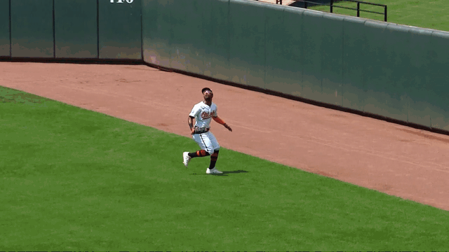 An animated gif of Cedric Mullins leaping high to rob a home run