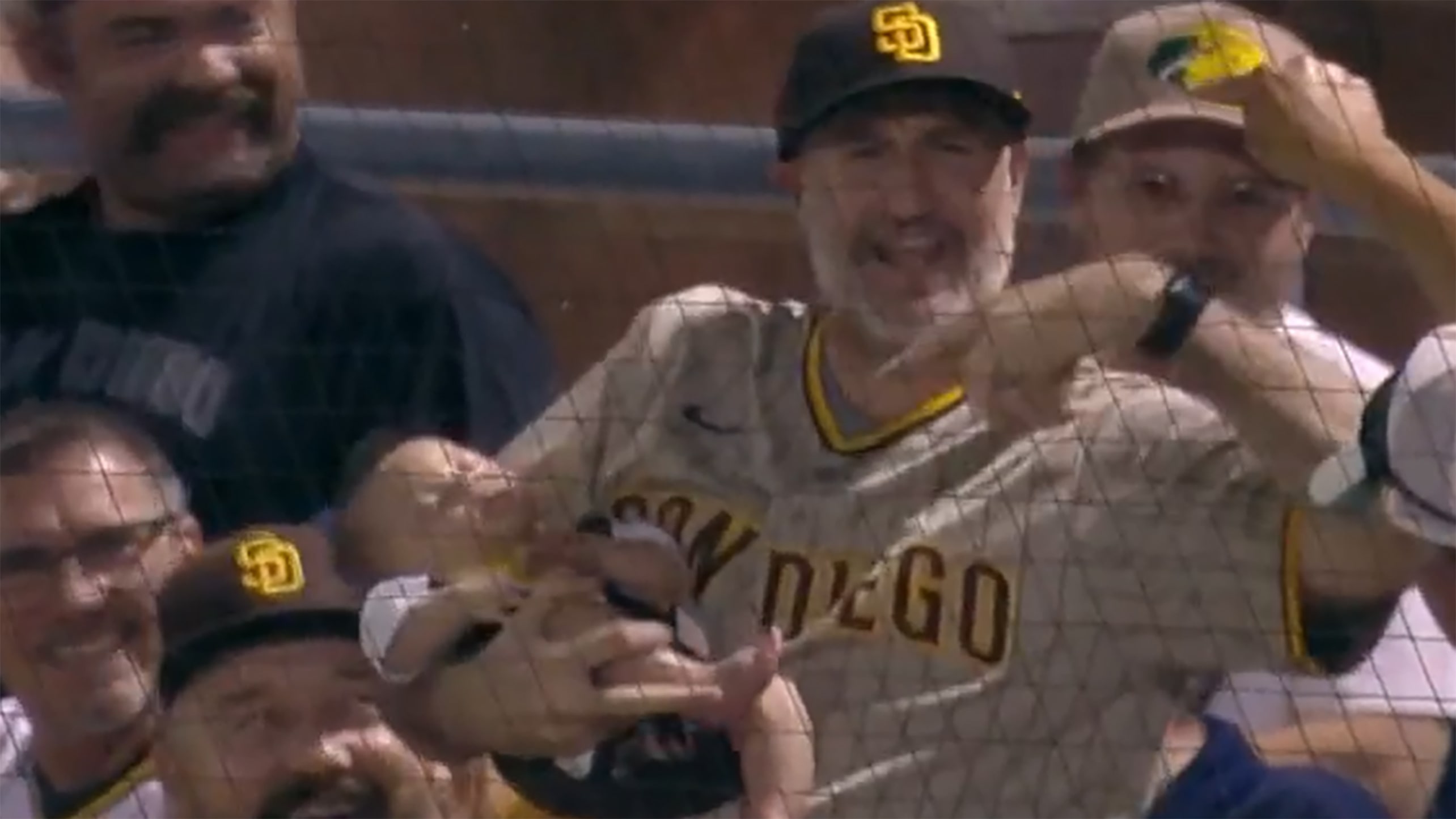 A Padres fan holding a baby