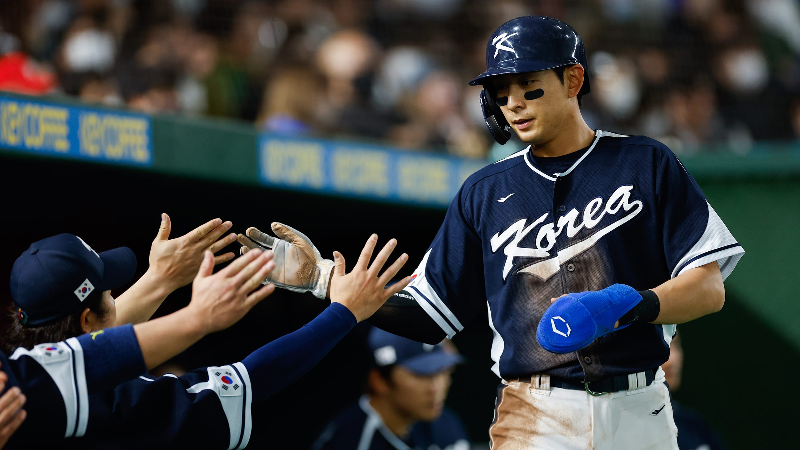Jung Hoo Lee high-fives teammates during the World Baseball Classic