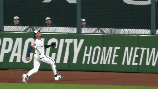 An animated gif of Astros center fielder Brice Matthews making a leaping catch before bumping into the wall