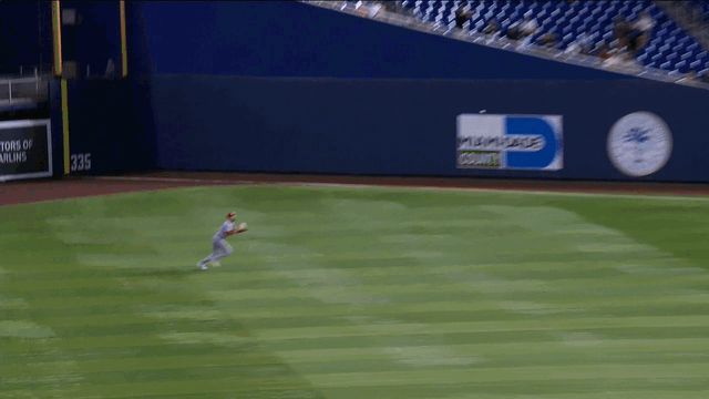 Dylan Carlson throws out a runner at the plate with a perfect throw