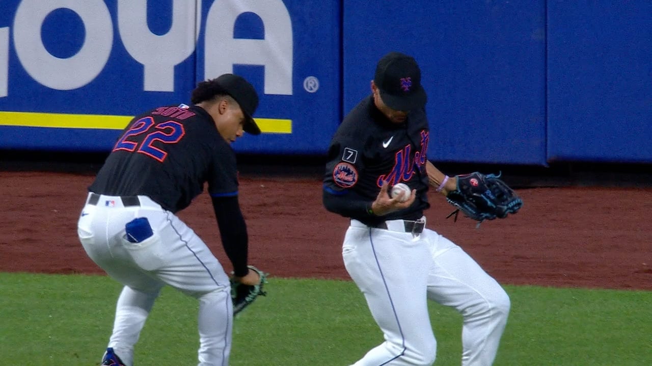 Mets center fielder Tyrone Taylor catches a ball after bumping into right fielder Juan Soto