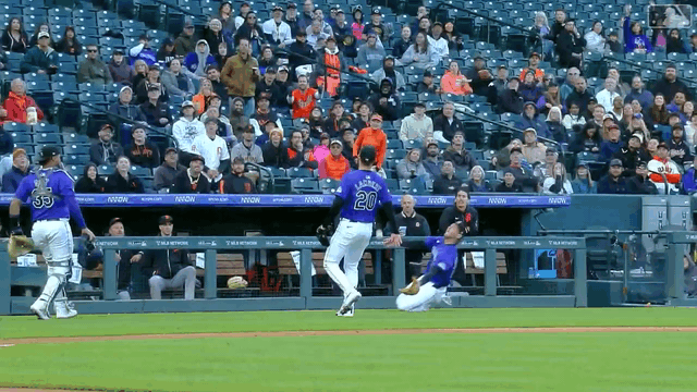 A sliding Ryan McMahon can't hang on to a foul popup -- but he tips the ball to catcher Elias Díaz