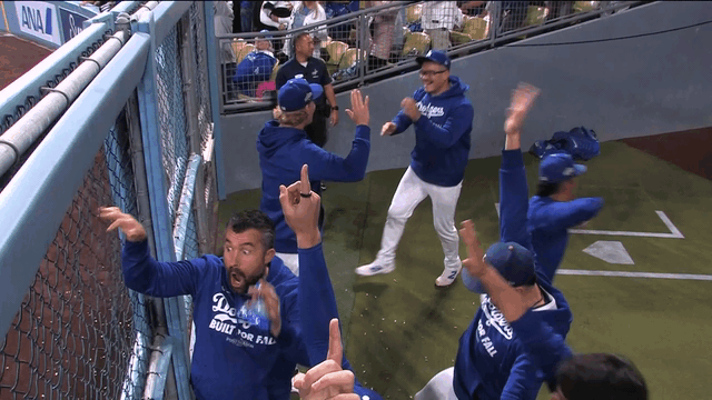 An animated gif of pitchers in the Dodgers' bullpen reacting in amazement to Shohei Ohtani's second homer