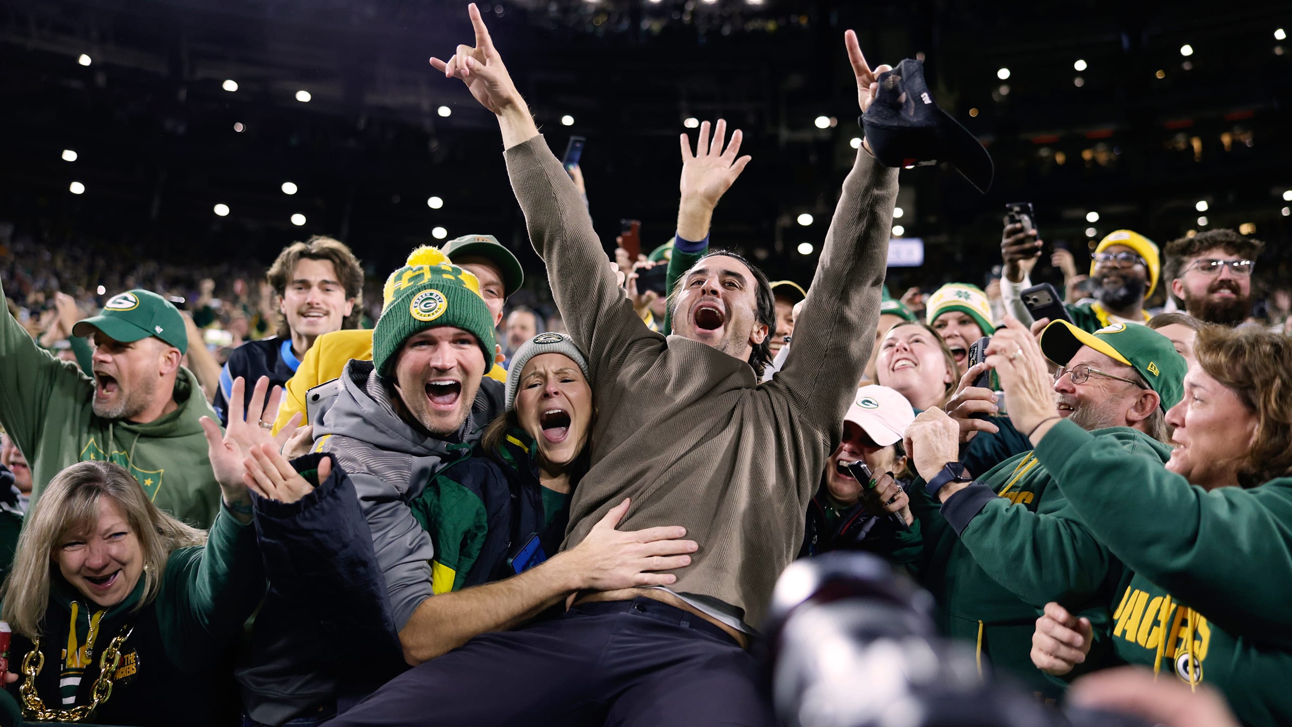 Sal Frelick leaps into the Lambeau Field stands