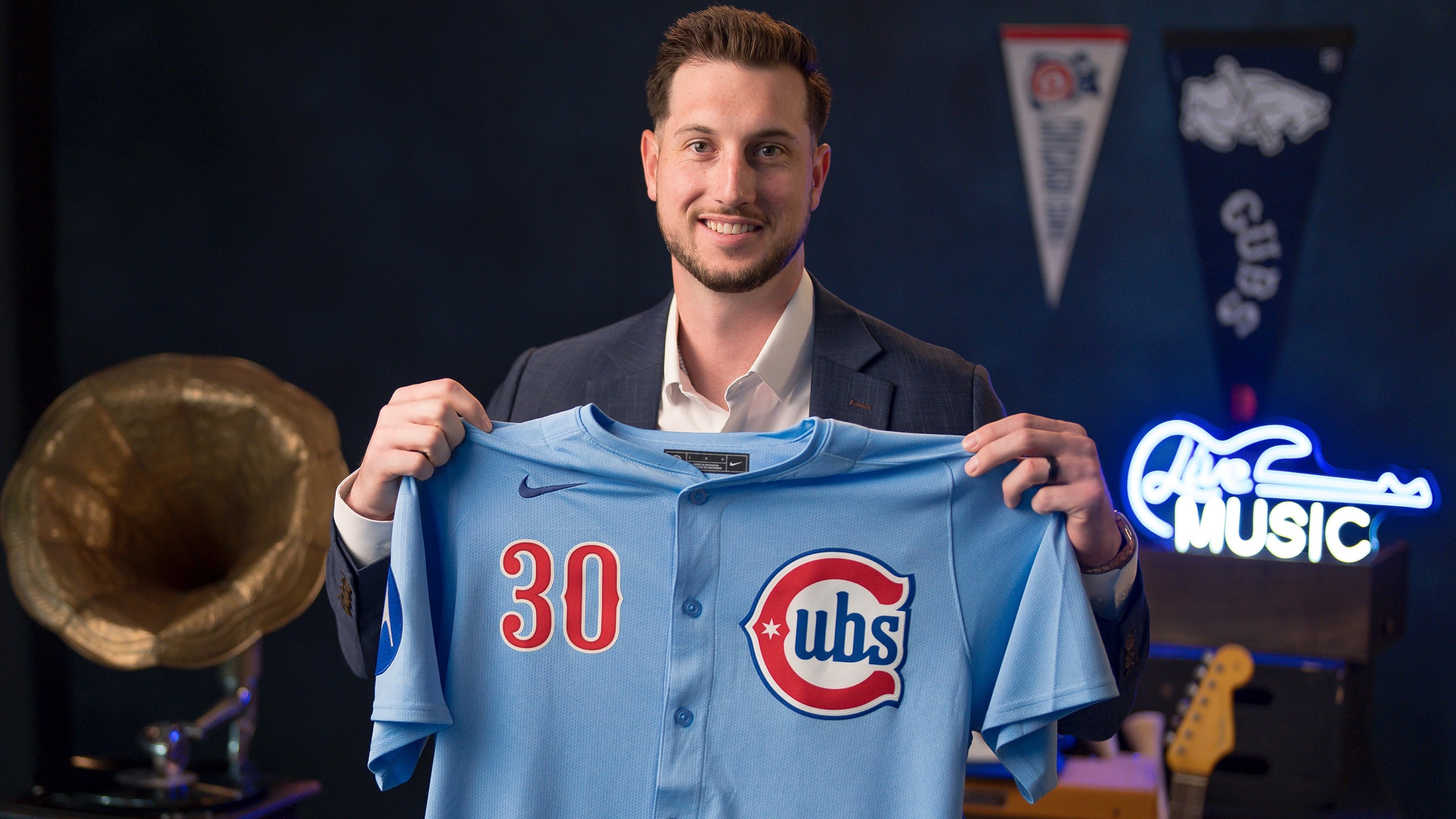 Kyle Tucker holds up the new Cubs alternate jersey