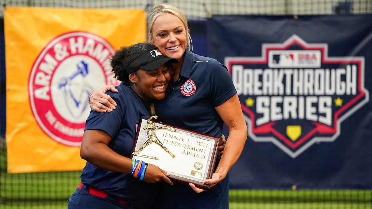 Jennie Finch hugs a young softball player