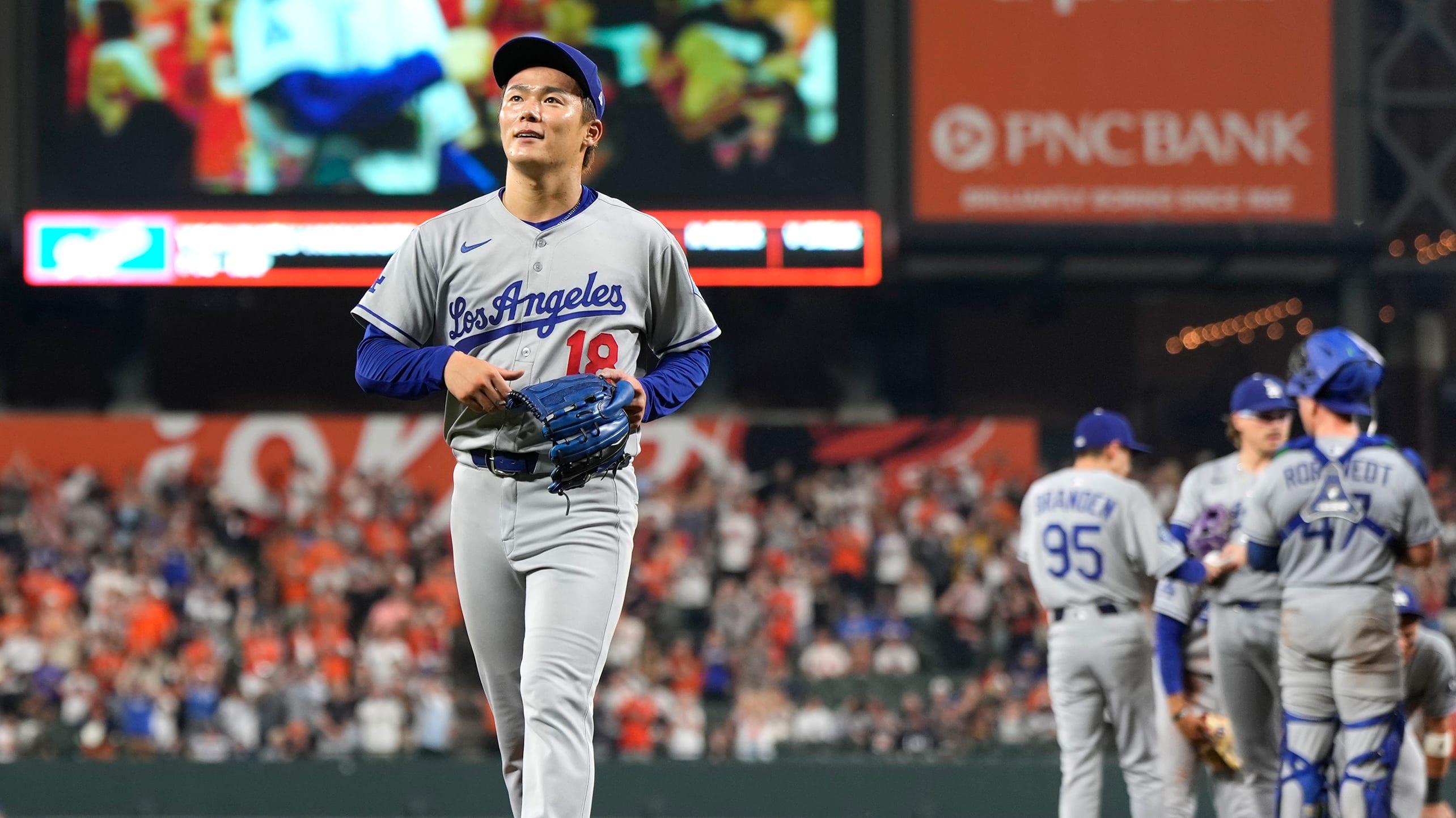Yoshinobu Yamamoto gets a hug on the mound after losing his no-hit bid