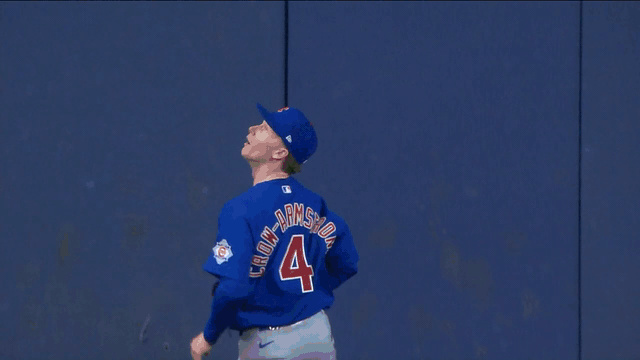 An animated gif of Pete Crow-Armstrong making a leaping catch at the wall