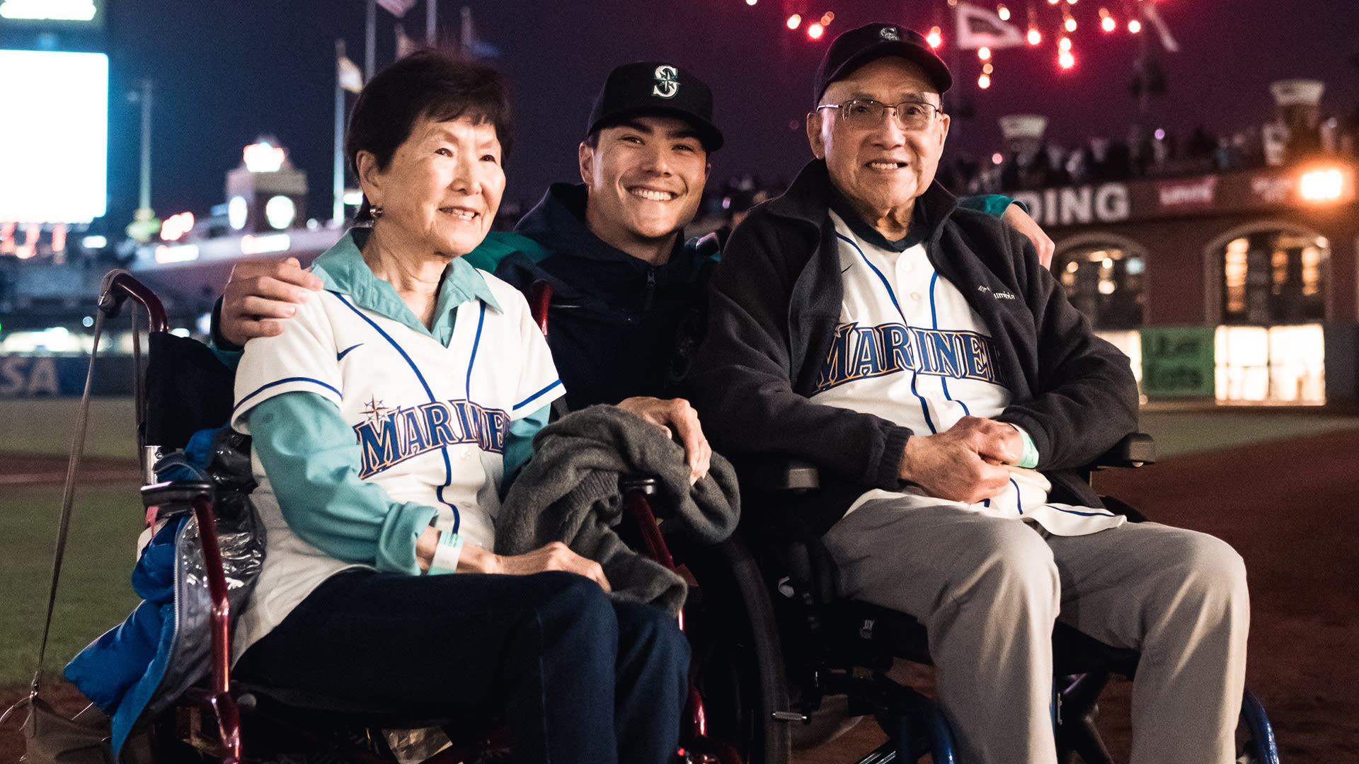 Mariners pitcher Bryan Woo between his grandparents