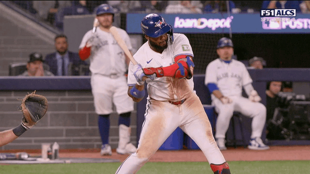 An animated gif of Vladimir Guerrero Jr. breaking his bat and hitting the ball three times on one swing