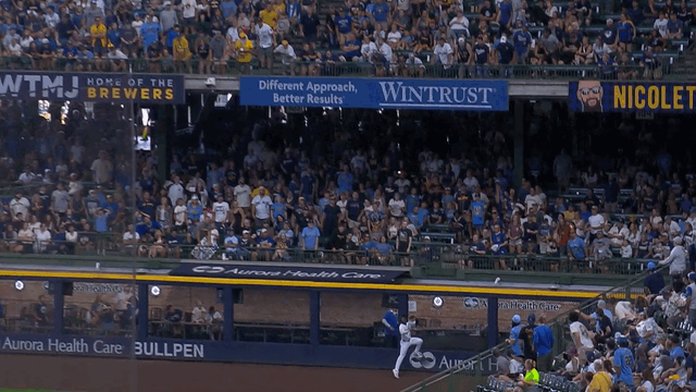 An animated gif of Luis Lara making a leaping catch against the wall