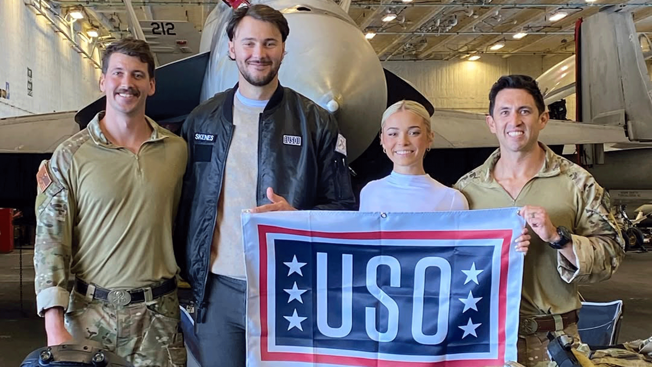 Paul Skenes and Livvy Dunne with two sailors