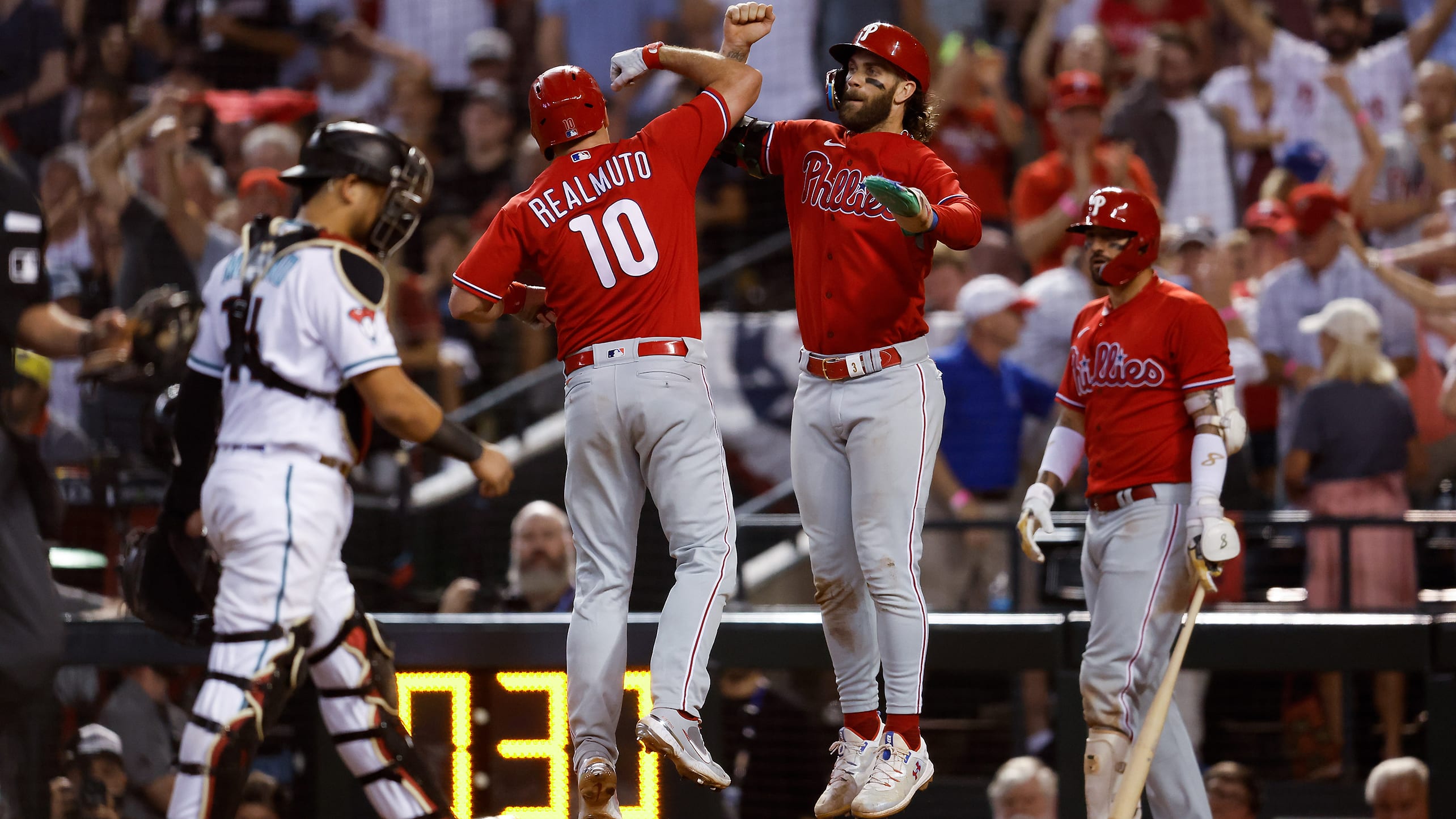 J.T. Realmuto and Bryce Harper celebrate at home plate