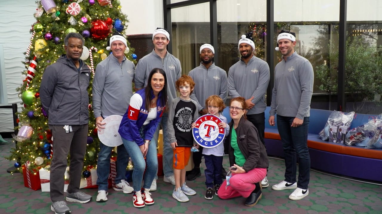 Rangers players and staff pose with kids at a children's hospital