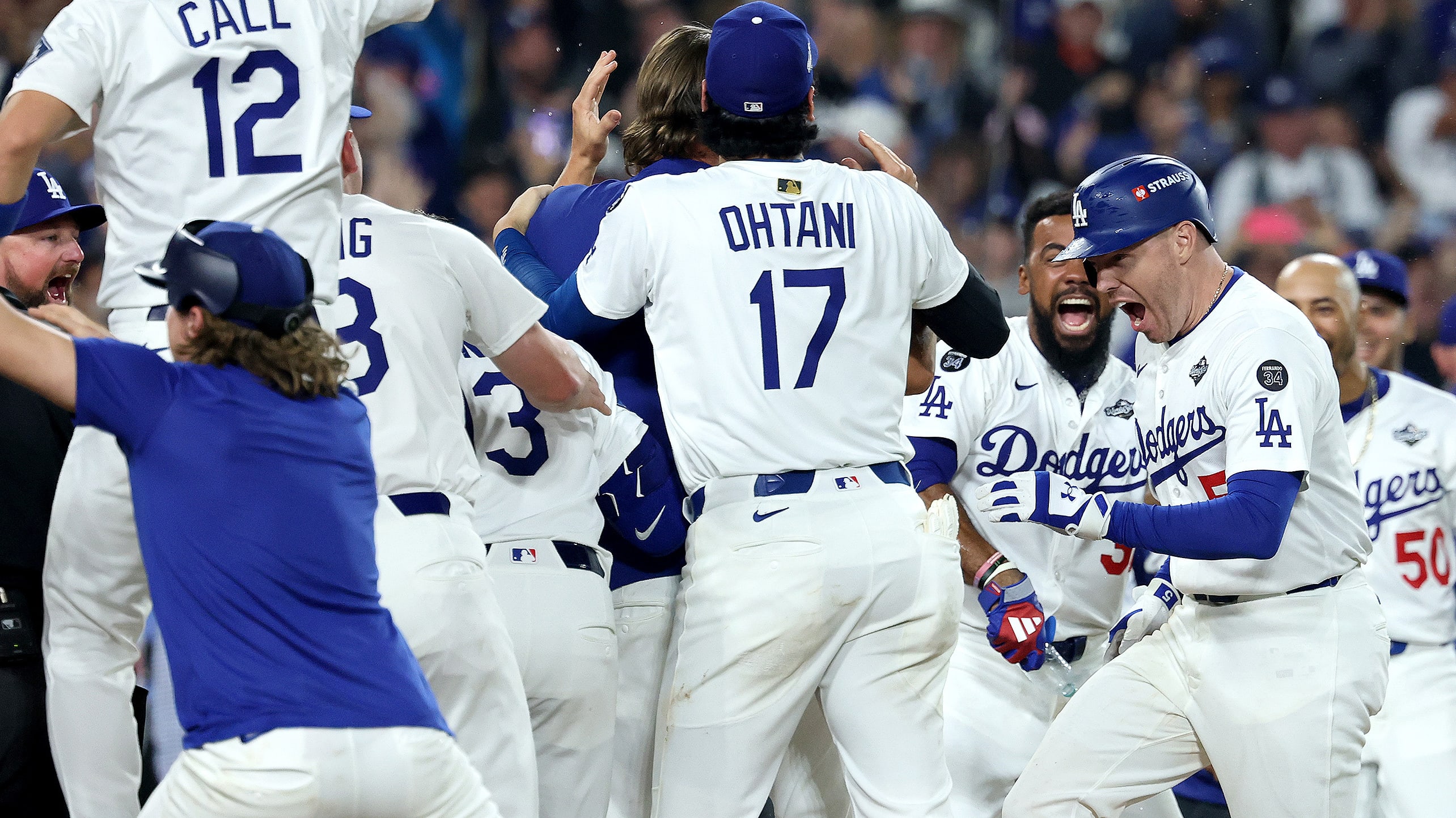 Freddie Freeman is greeted at home plate by the Dodgers