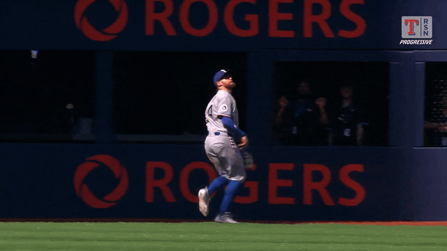 An animated gif of Brandon Nimmo crashing into the wall on a leaping catch